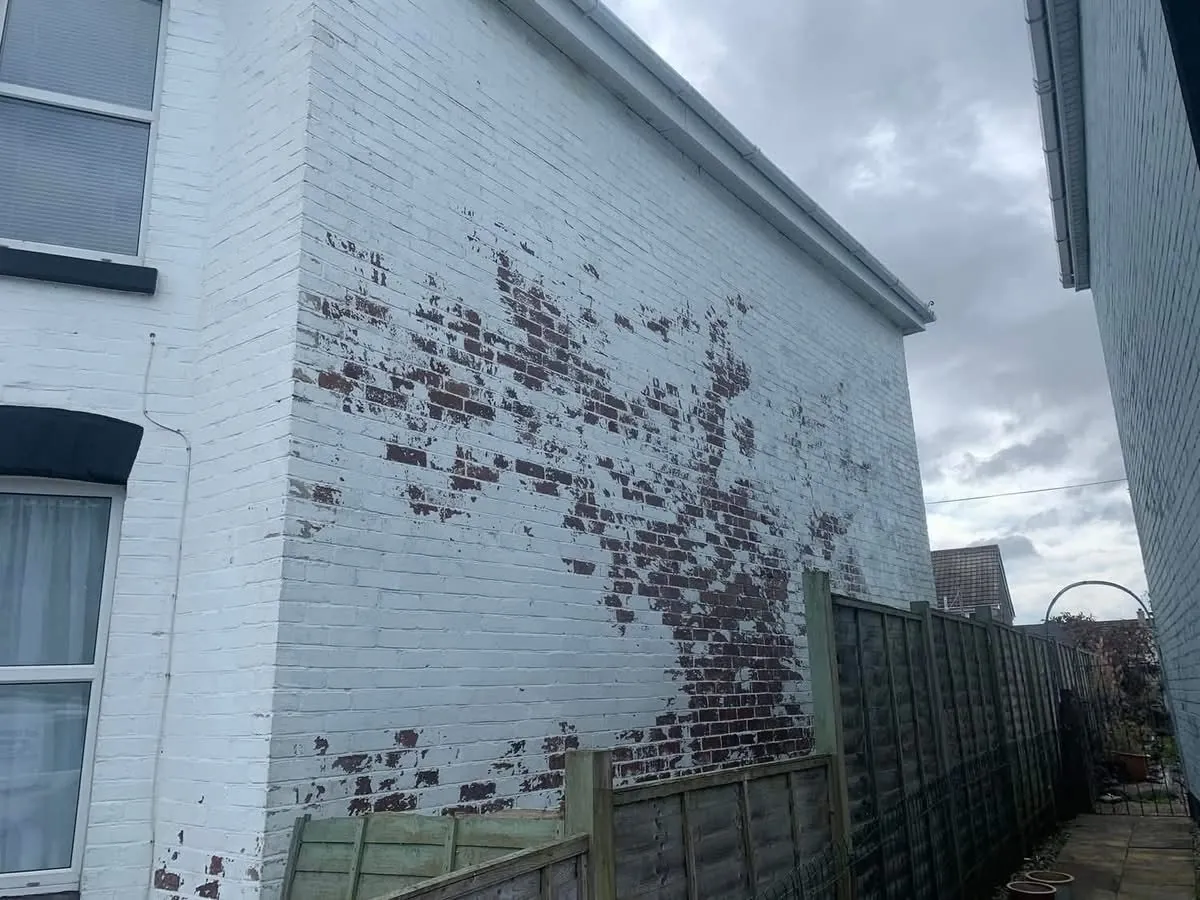 Peeling paint on a brick wall before redecoration in Sennen