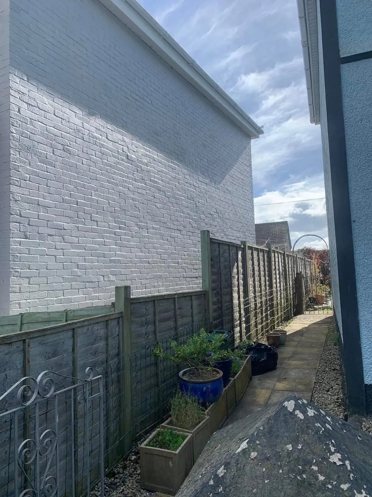 Freshly painted brick wall after preparation and masonry paint in Sennen