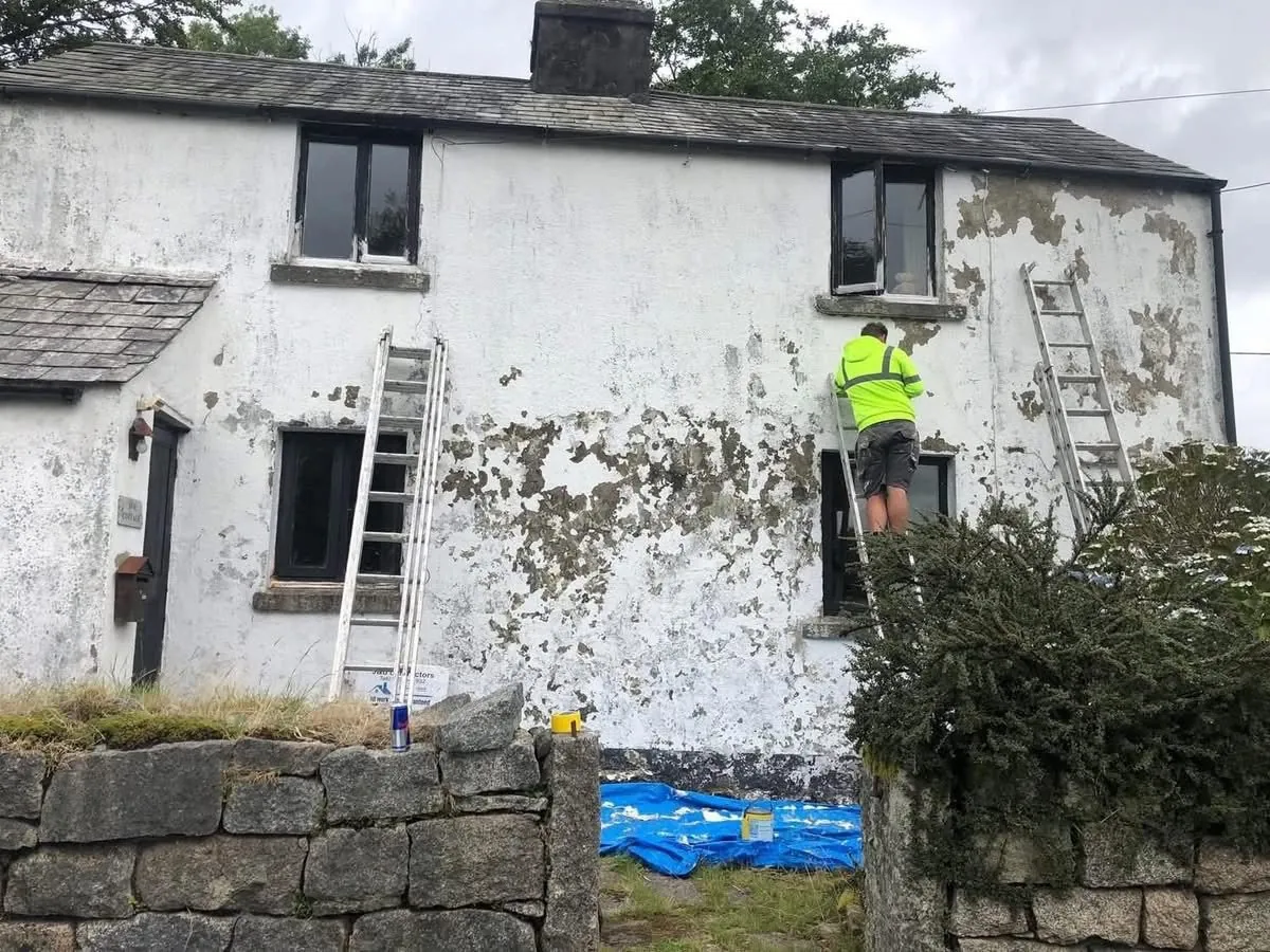 Cottage with blown, flaking render before repair in Sennen